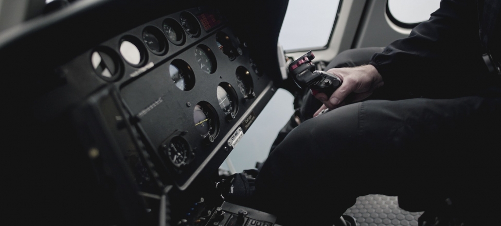 Aeroplane engine with the pilot's hand on the centre stick (credit: Skycraft Studios on Unsplash)